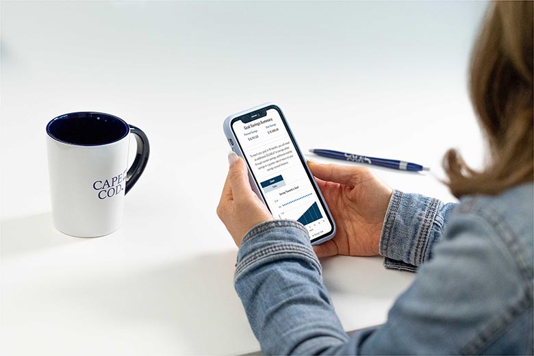 Woman on cell phone using Cape Cod 5 financial calculators