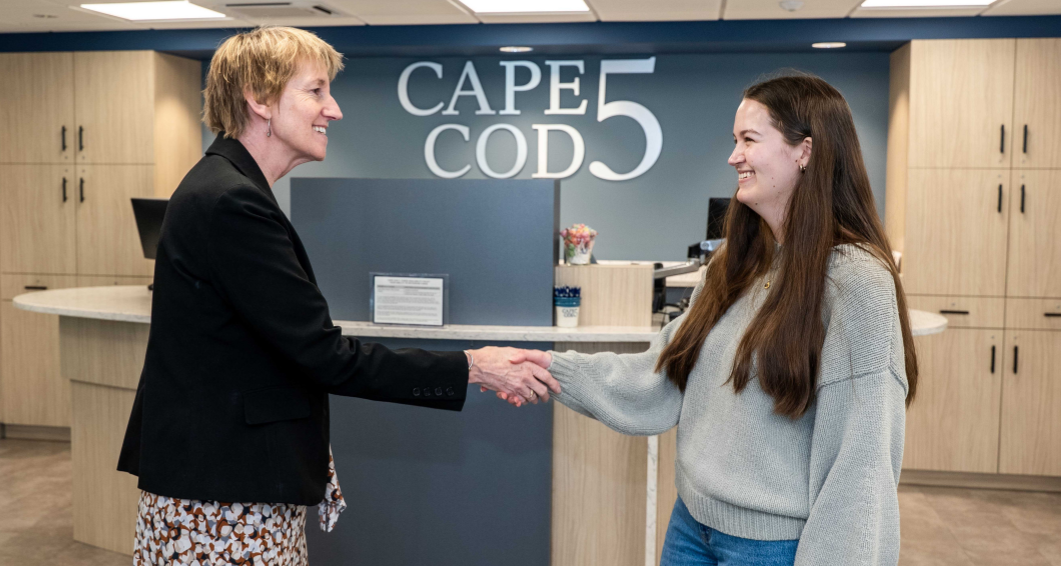 Cape Cod 5 Banking Center Manager shaking hands with client in lobby