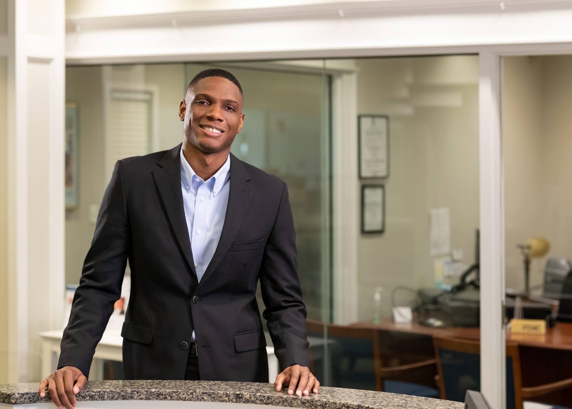 Leonardo Atkinson standing at desk in Banking Center