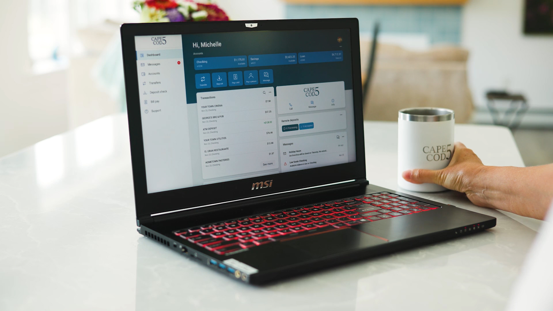 Laptop with Cape Cod 5 coffee mug on table