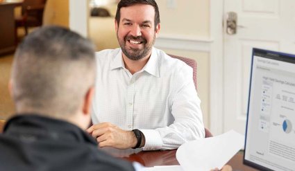 Cape Cod 5 Banking Center Manager helping client at desk