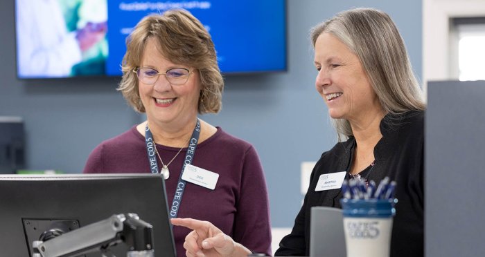 Two bankers at teller line