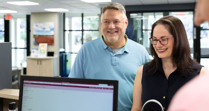 Man and woman at Banking Center teller line
