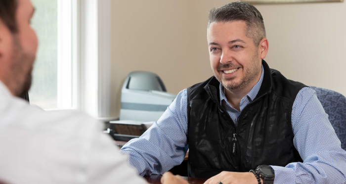 Banking Center Manager at desk helping client