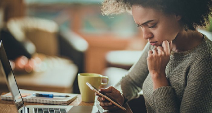 Concerned woman looking at mobile phone