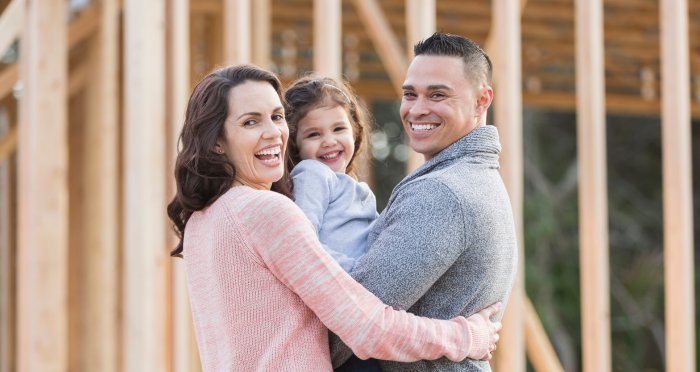 Happy young family building new home