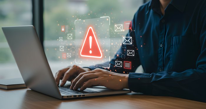Cyber security alert email phishing scam warning on laptop computer with exclamation point triangle sign