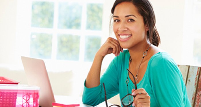 Smiling woman sitting at computer