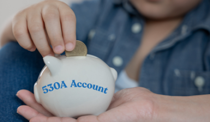 Child adding a coin to a piggy bank 530A Account