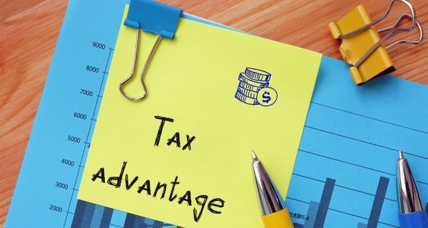 Financial Paperwork with pens, paper clips, sticky note Tax Advantage