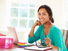 Smiling woman sitting at computer